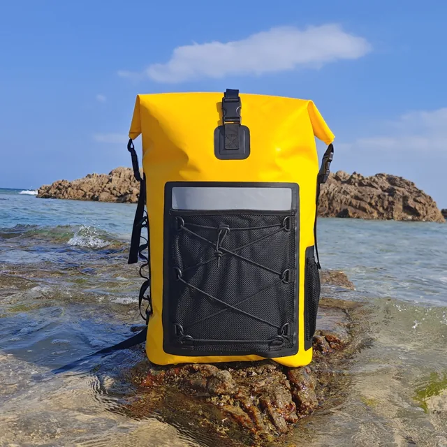 Yellow backpack standing on coastal rocks
